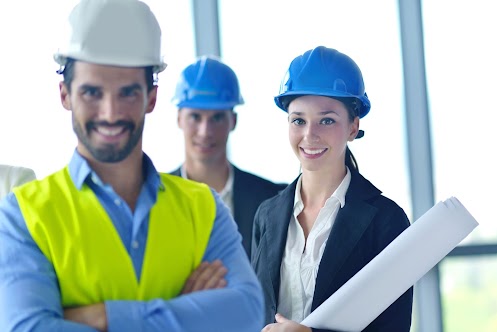 values and edge business people group on meeting and presentation in bright modern office with construction engineer architect and worker looking building model and blueprint plans